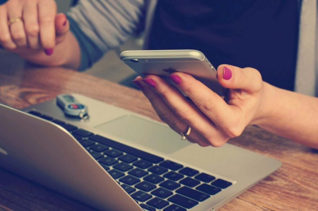 woman is looking at her mobile phone
