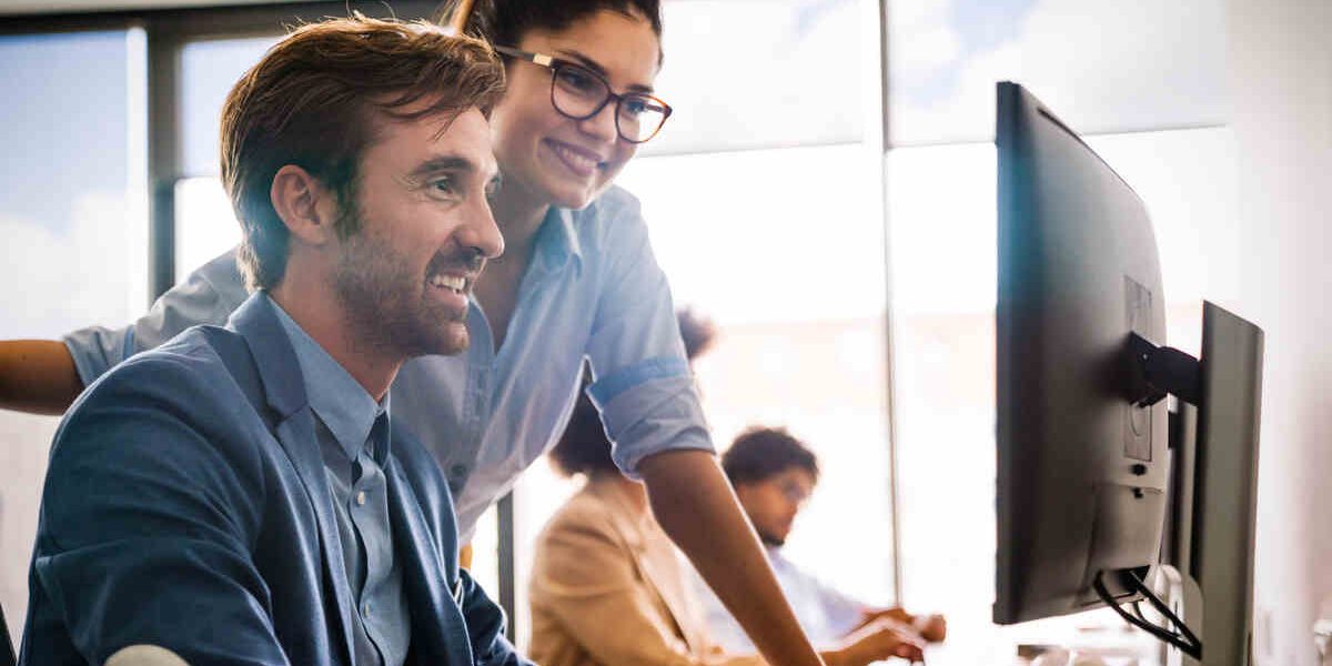 Portrait of business team working together in office representing hero image for Lead Generation Tools
