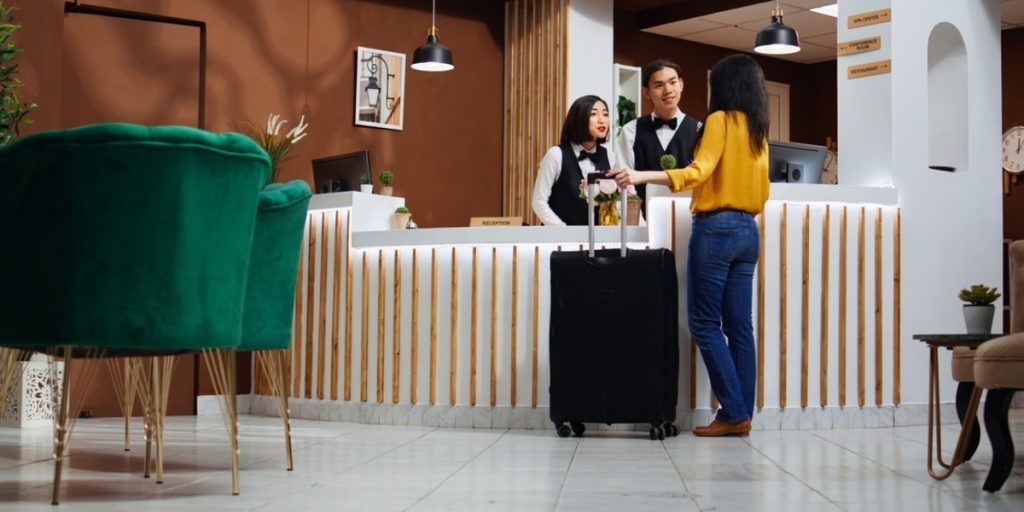 image showing front desk and several people representing hospitality outsourcing 